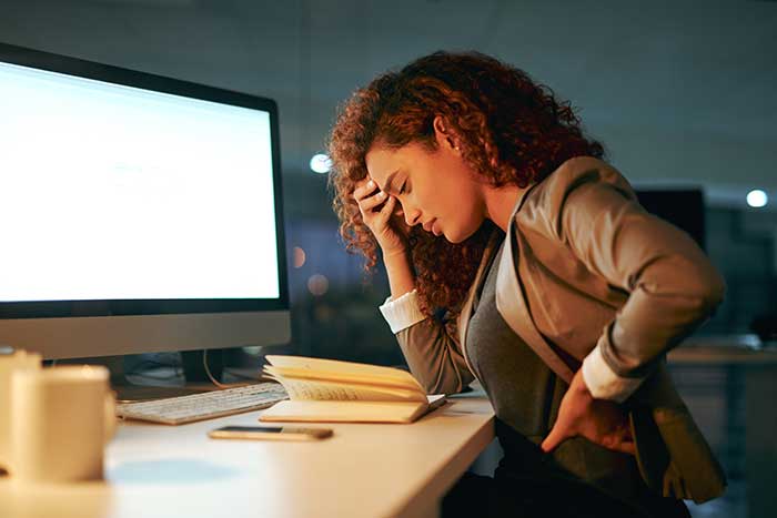 Women at desk having back pain