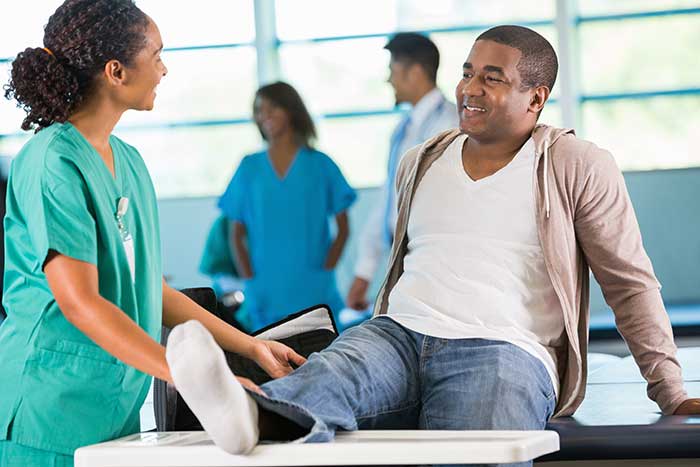 Physical therapist helping patient