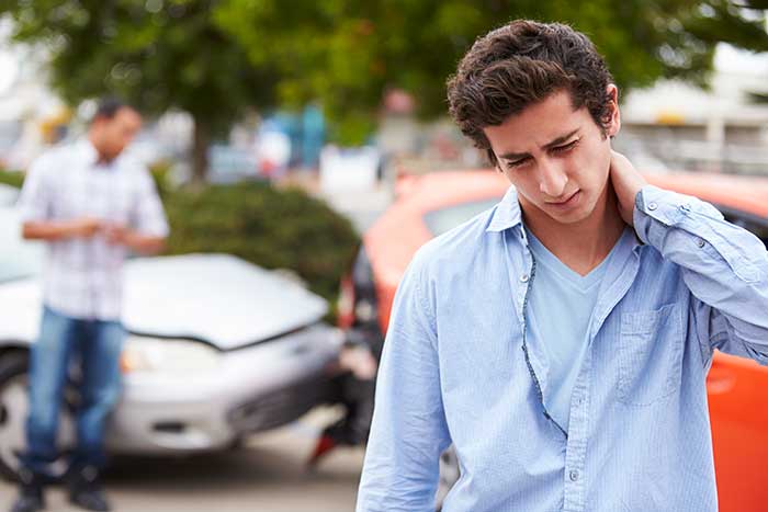 guy holding neck after auto accident